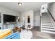 Open-concept living area with modern finishes, hardwood floors, and a staircase at 2676 Brookview Nw Ln, Atlanta, GA 30318