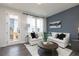 Stylish living room with a comfortable white couch, accent wall, and sunlit windows at 2676 Brookview Nw Ln, Atlanta, GA 30318