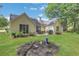 View of the home's back exterior with a patio, grill, and landscaped yard at 3001 Garland Sw Dr, Marietta, GA 30008