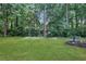 Expansive backyard with lush green lawn and mature trees offers a private oasis at 3001 Garland Sw Dr, Marietta, GA 30008