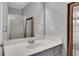 Bathroom featuring white countertops, gray cabinets, and a glass-enclosed shower at 3001 Garland Sw Dr, Marietta, GA 30008