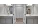 Dual vanity bathroom with gray cabinets, and framed mirrors at 3001 Garland Sw Dr, Marietta, GA 30008