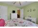 Cozy bedroom with green walls, white dresser, and comfortable floral bedding at 3001 Garland Sw Dr, Marietta, GA 30008