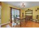 Bright dining room features a wooden table with seating, accent lighting, and hardwood floors at 3001 Garland Sw Dr, Marietta, GA 30008