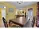 Bright dining area with yellow walls, hardwood floors, decorative curtains and views into the living room at 3001 Garland Sw Dr, Marietta, GA 30008