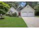 Inviting home showcasing a well-maintained lawn, brick accents, a red front door, and a two-car garage at 3001 Garland Sw Dr, Marietta, GA 30008