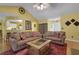 Open-concept living room featuring wood floors, comfortable sofas, and seamless access to the kitchen at 3001 Garland Sw Dr, Marietta, GA 30008