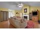 Spacious living room with a fireplace, ceiling fan, wood floors, and an open layout at 3001 Garland Sw Dr, Marietta, GA 30008