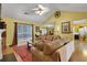 Bright living room with wood floors, a ceiling fan, comfortable seating, and an open view to the kitchen at 3001 Garland Sw Dr, Marietta, GA 30008