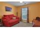 Cozy living room features a red sofa, a window for natural light, and a wood accent chest at 3001 Garland Sw Dr, Marietta, GA 30008
