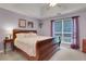 Spacious main bedroom featuring tray ceiling, dark furnishings, and neutral carpeting at 3001 Garland Sw Dr, Marietta, GA 30008