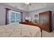 Bright main bedroom with tray ceiling, wooden furnishings, and large window at 3001 Garland Sw Dr, Marietta, GA 30008