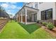 Backyard and covered patio area with a view of a well-manicured lawn at 711 Dodd N Ln # 166, Buford, GA 30518