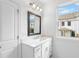Modern bathroom with single vanity, framed mirror and natural light from window at 711 Dodd N Ln # 166, Buford, GA 30518