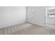 Cozy bedroom with carpeted flooring, a window and a doorway at 711 Dodd N Ln # 166, Buford, GA 30518