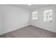 Neutral carpeted bedroom with two windows allowing in plenty of natural light at 711 Dodd N Ln # 166, Buford, GA 30518