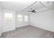 Primary bedroom with a tray ceiling, ceiling fan, and large windows letting in natural light at 711 Dodd N Ln # 166, Buford, GA 30518