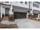 Attractive townhouse exterior with brick accents, a two-car garage, and well-manicured landscaping for great curb appeal at 711 Dodd N Ln # 166, Buford, GA 30518