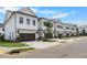 Street view of townhomes with two-car garages and nicely maintained landscaping at 711 Dodd N Ln # 166, Buford, GA 30518