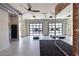 Bright gym space featuring treadmills, garage doors for open-air workouts, and exposed brick at 711 Dodd N Ln # 166, Buford, GA 30518