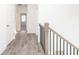 Upstairs hallway with gray vinyl floors, white walls, and a staircase with wood railing at 711 Dodd N Ln # 166, Buford, GA 30518