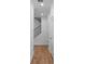Long hallway with hardwood floors and a staircase with black iron railings at 711 Dodd N Ln # 166, Buford, GA 30518