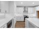 Kitchen features white cabinets, stainless steel appliances, and quartz countertops at 711 Dodd N Ln # 166, Buford, GA 30518