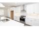 Modern kitchen features stainless steel appliances, white cabinetry, and sleek countertops at 711 Dodd N Ln # 166, Buford, GA 30518