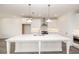 Spacious kitchen has stainless steel appliances, a large island, pendant lighting, and sleek, white cabinets at 711 Dodd N Ln # 166, Buford, GA 30518