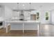 An open kitchen has white cabinets, an island, and a view to the living area at 711 Dodd N Ln # 166, Buford, GA 30518