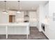 Modern kitchen boasts an island, stainless steel appliances, white cabinetry, and hardwood floors, perfect for cooking at 711 Dodd N Ln # 166, Buford, GA 30518