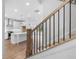 View of the kitchen from the staircase, featuring a center island and modern appliances at 711 Dodd N Ln # 166, Buford, GA 30518