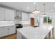 Kitchen features white cabinets, stainless steel appliances, and a large center island at 711 Dodd N Ln # 166, Buford, GA 30518
