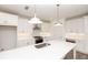 Bright kitchen has stainless steel appliances, a central island, pendant lighting, and white cabinets, creating a modern space at 711 Dodd N Ln # 166, Buford, GA 30518
