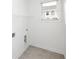 Bright laundry room with wire shelving unit and neutral floors at 711 Dodd N Ln # 166, Buford, GA 30518