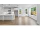 Open concept living room with hardwood floors, recessed lighting and large bright windows at 711 Dodd N Ln # 166, Buford, GA 30518