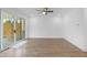 Open living room with hardwood floors and sliding glass doors to the backyard at 711 Dodd N Ln # 166, Buford, GA 30518