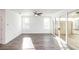 Open-concept living room features hardwood floors, a ceiling fan, and sliding door access to back deck at 711 Dodd N Ln # 166, Buford, GA 30518