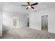 Large main bedroom featuring ceiling fan and adjoining bathroom and walk-in closet at 711 Dodd N Ln # 166, Buford, GA 30518