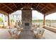 Inviting outdoor seating area with stone fireplace and wood ceiling at 711 Dodd N Ln # 166, Buford, GA 30518