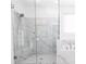 Modern glass enclosed shower with white marble tile, and a rain shower head, providing a luxurious bathing experience at 711 Dodd N Ln # 166, Buford, GA 30518