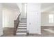 View of a modern staircase with wood railing and white risers, leading to the upper level of the home at 711 Dodd N Ln # 166, Buford, GA 30518