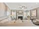 Living room with a ceiling fan, fireplace, neutral walls, and plenty of natural light at 104 Asher Dr, Carrollton, GA 30116