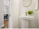 Stylish half-bath featuring pedestal sink with designer faucet and view into the dining room at 1199 Huff Nw Rd # 127, Atlanta, GA 30318
