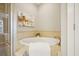 Bright soaking tub features tile surround and a decorative plant near a glass-enclosed shower at 1199 Huff Nw Rd # 127, Atlanta, GA 30318