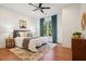 Comfortable bedroom features a ceiling fan, bright window, and a decorative rug at 1199 Huff Nw Rd # 127, Atlanta, GA 30318