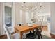 Open concept dining area with hardwood floors, stylish lighting, and a view into the kitchen at 1199 Huff Nw Rd # 127, Atlanta, GA 30318