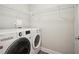 Well-organized laundry room featuring a modern washer and dryer, along with wire shelving for convenient storage solutions at 1199 Huff Nw Rd # 127, Atlanta, GA 30318