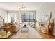 Bright living room features hardwood floors, large windows, and stylish decor for a welcoming atmosphere at 1199 Huff Nw Rd # 127, Atlanta, GA 30318