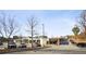 An outdoor streetscape featuring shops, parking spaces, and sparse trees, creating a welcoming commercial environment at 1199 Huff Nw Rd # 127, Atlanta, GA 30318